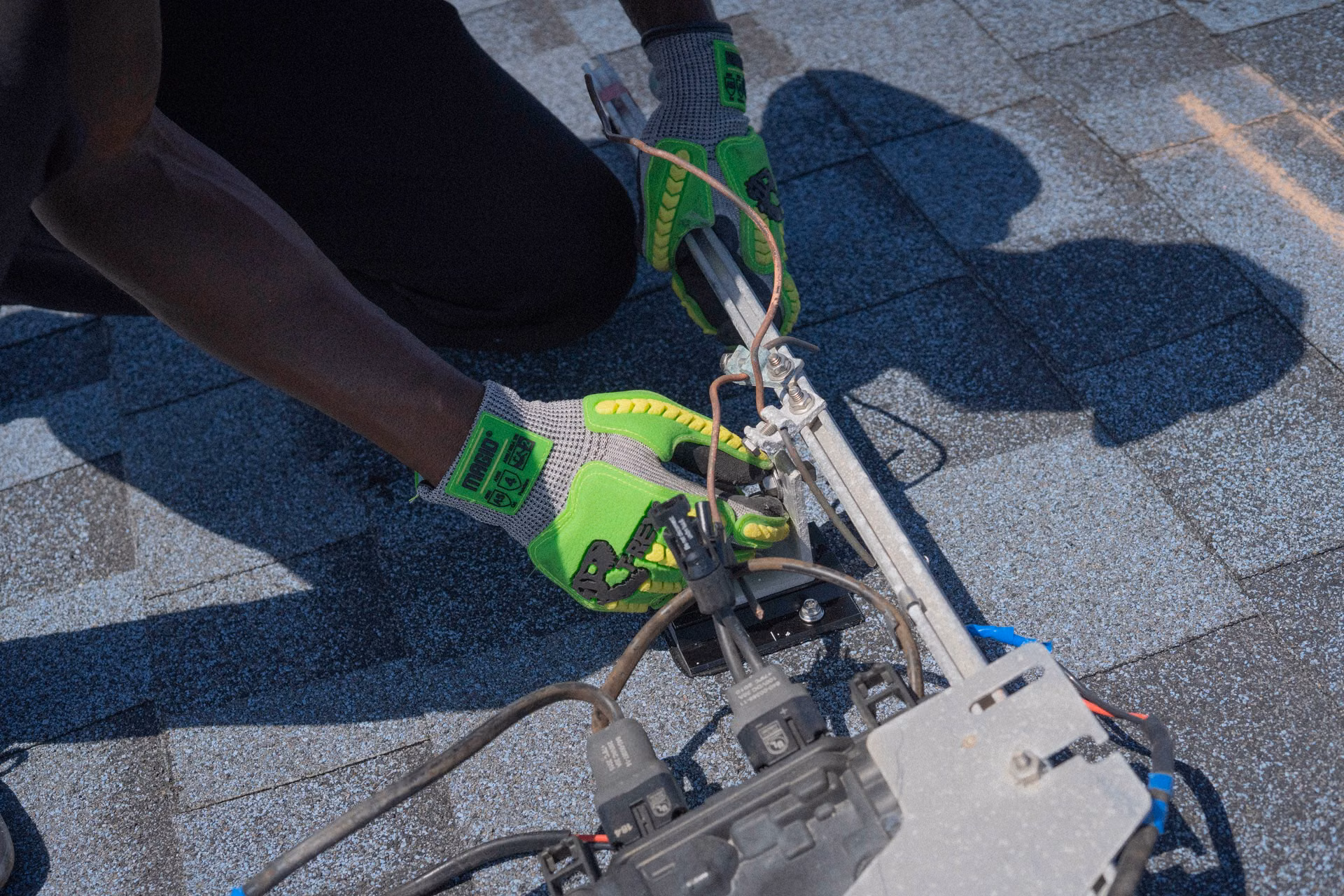 Close-up of a roofer fastening shingles