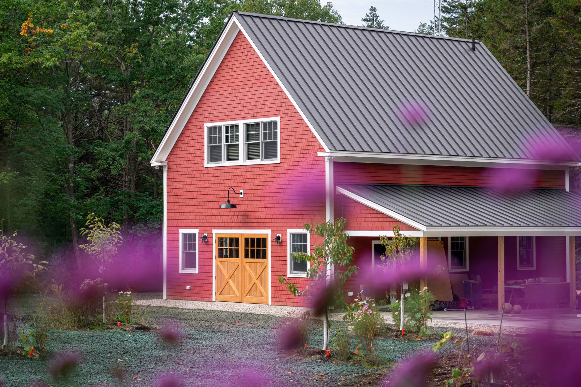 Red barn-style home with a standing seam metal roof